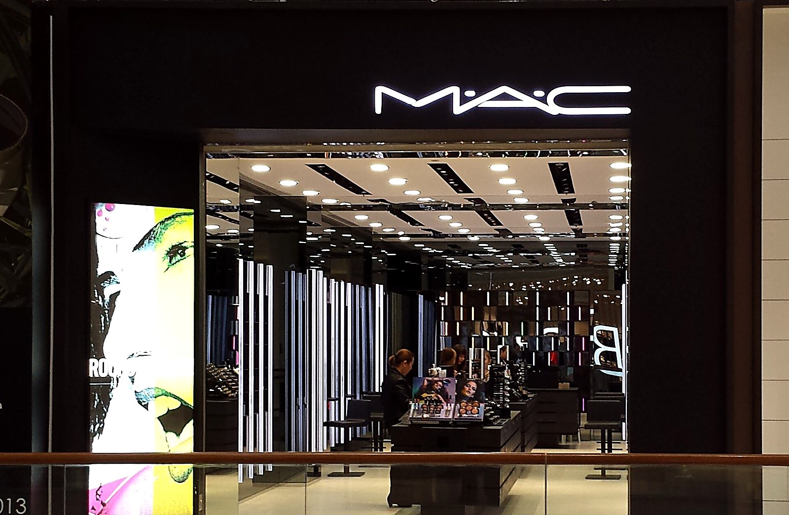 A dark MAC storefront with a glowing neon wordmark